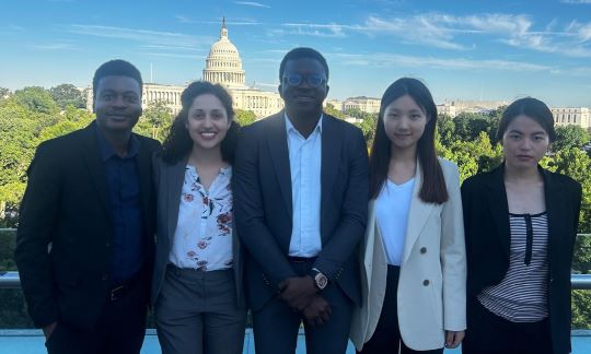 five students in front of the capital building