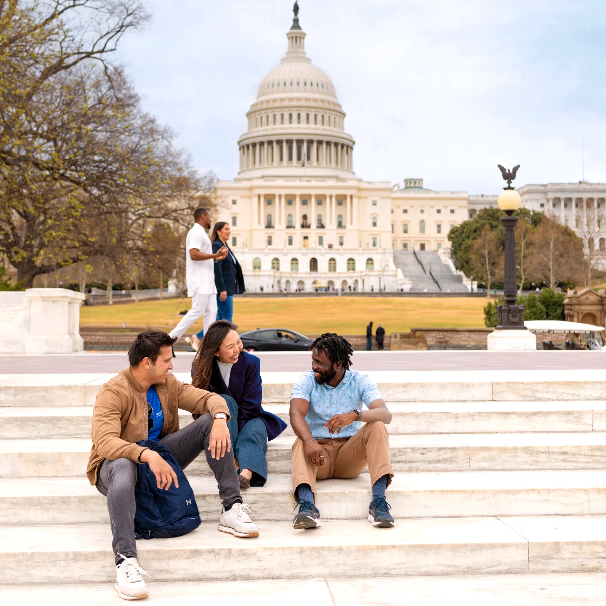 Students sitting on steps in front of the Capital building in Washington, D.C.