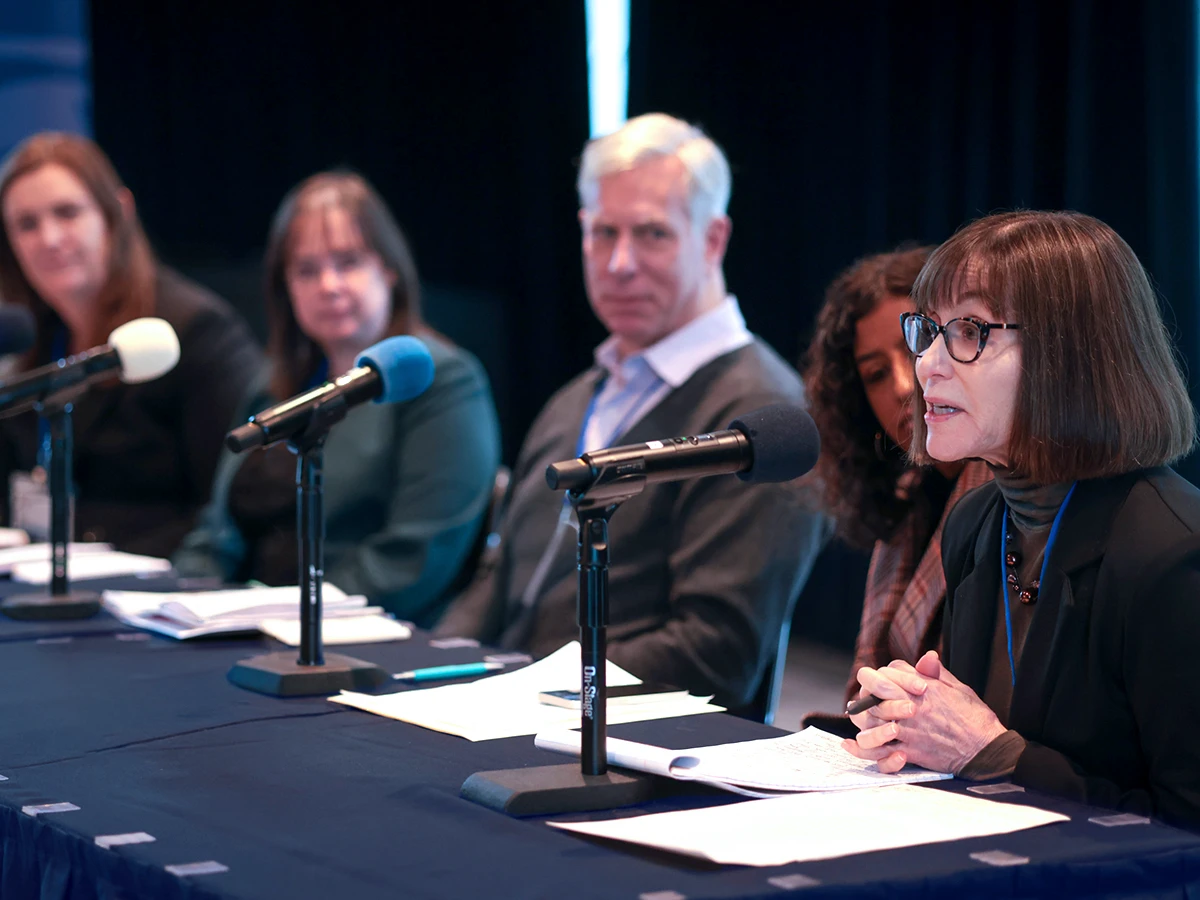 Faculty sitting on a panel at an event.