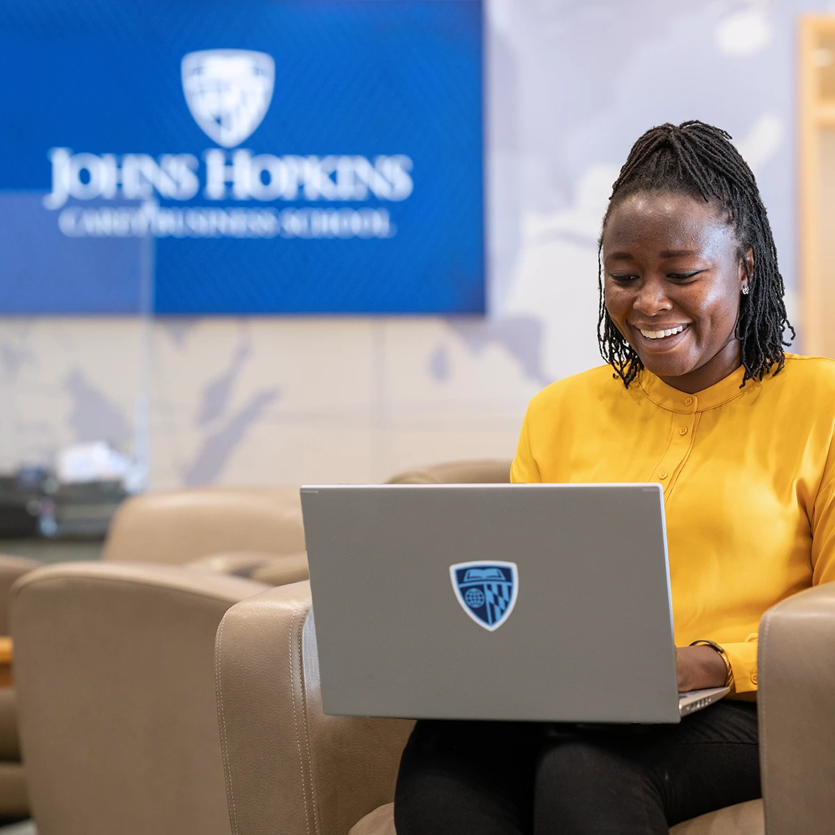 Student working on computer at Carey Business School.
