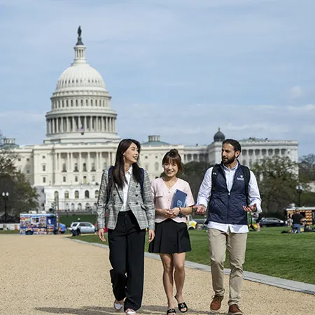 Students walking in front of the Capital Building