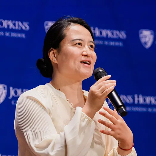 speaker holding a microphone