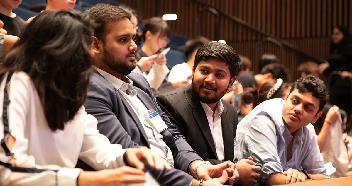 Students sitting at a presentation in a theater at Johns Hopkins Bloomberg Center.