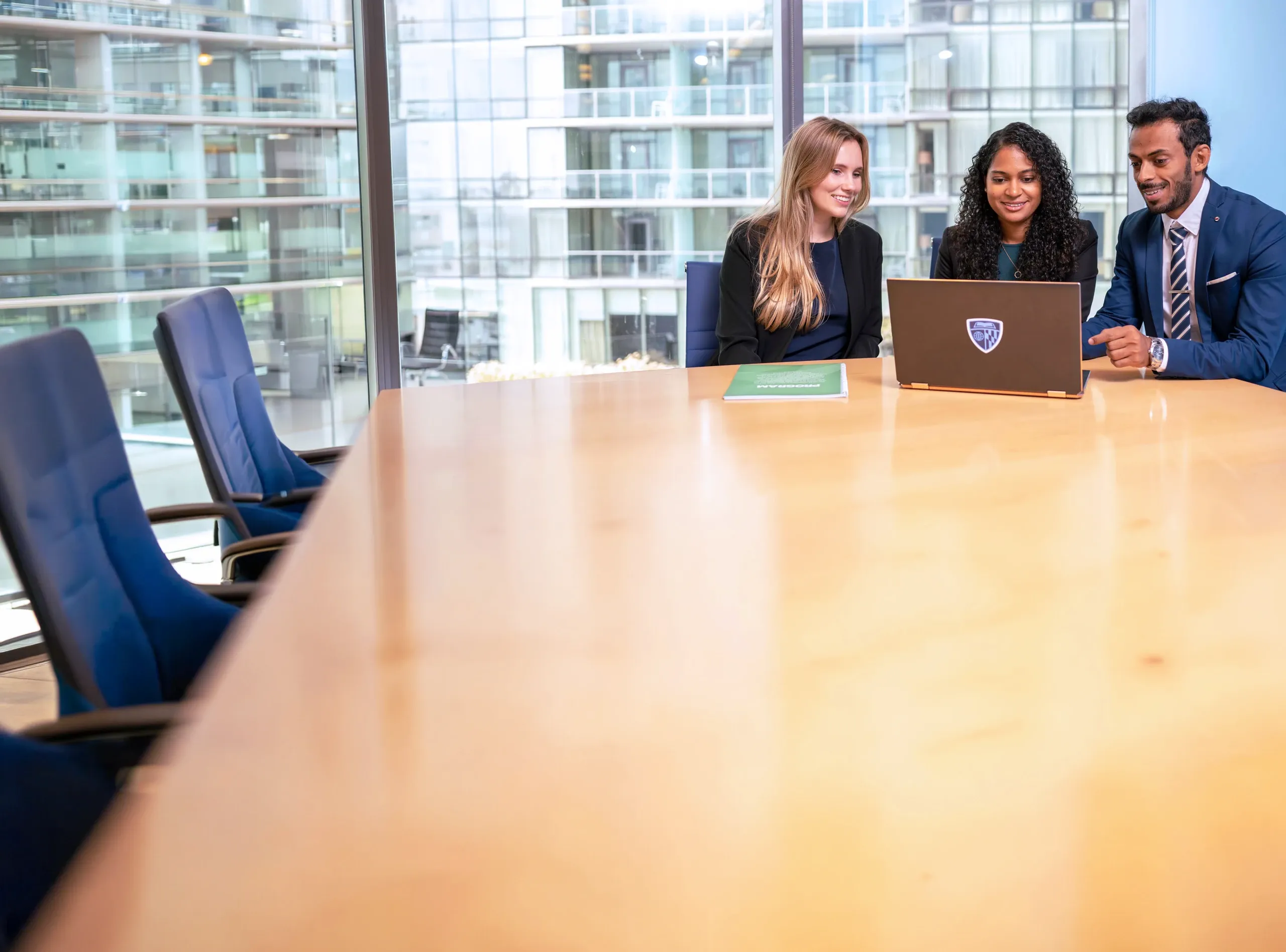 Participants working together on a computer sitting at a table