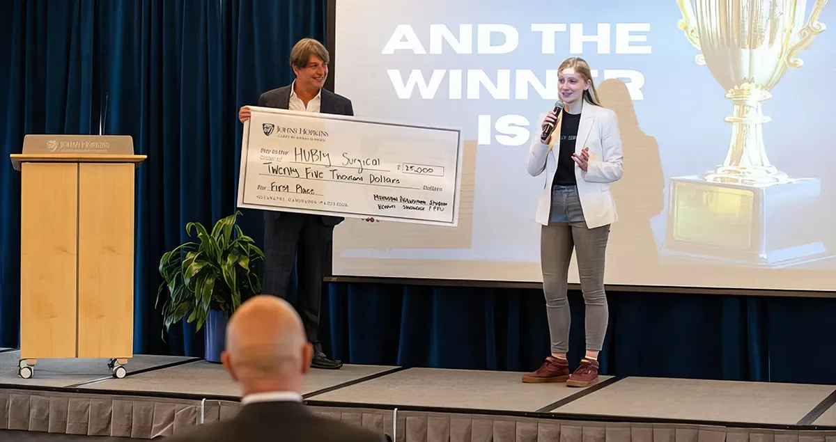 Student receiving award on stage at Student Venture Showcase