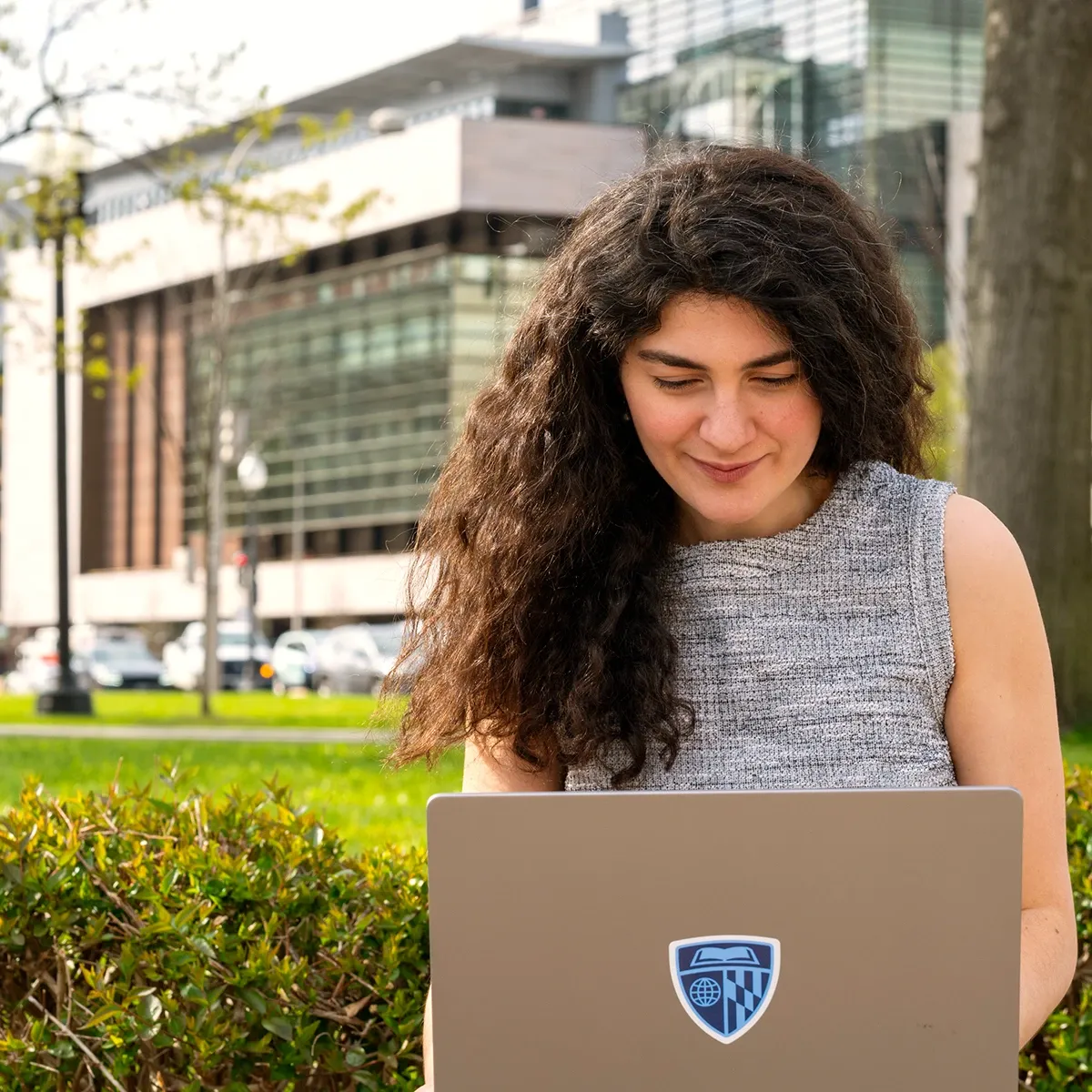 Student working on computer outside of the Johns Hopkins Bloomberg Center