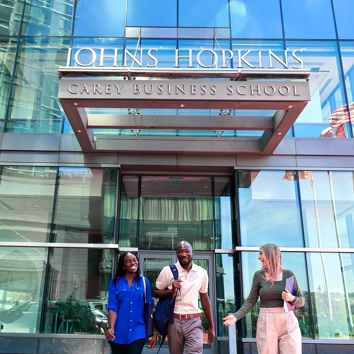 Students walking outside of the Carey Business School entrance in Baltimore, Maryland