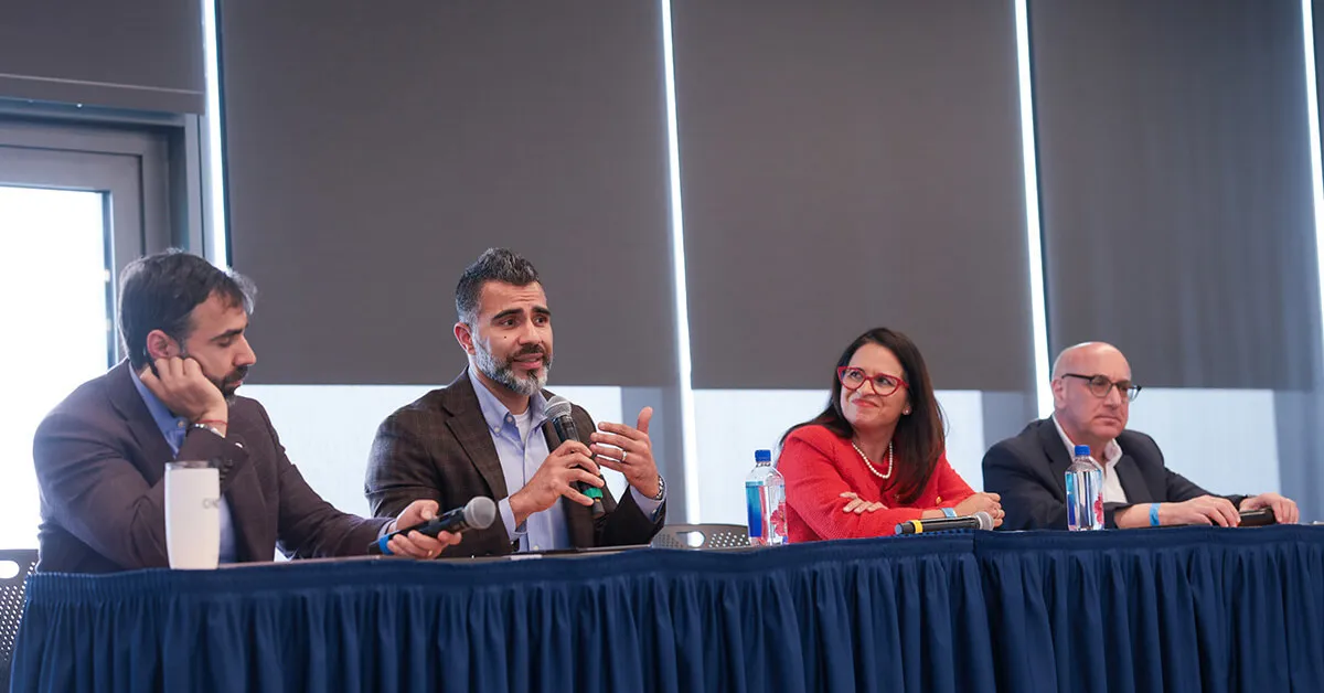 four person panel at the front panel stage speaking