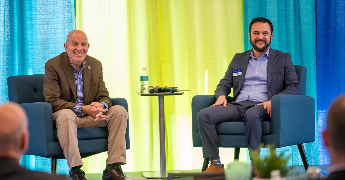 Brandon Smart and Eric Helzer seated on stage interacting with the audience