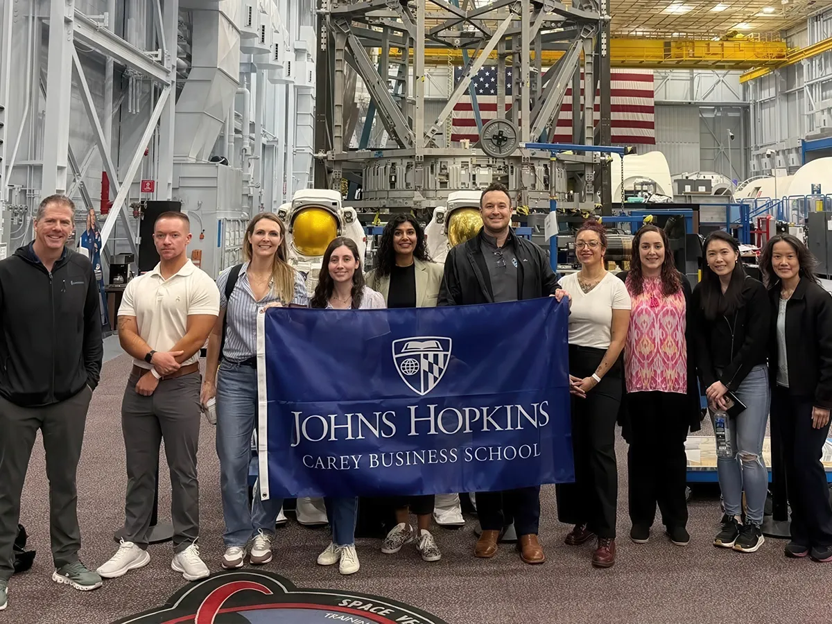 CIL group photo with Carey Banner in a Space Vehicle Mockup Facility.