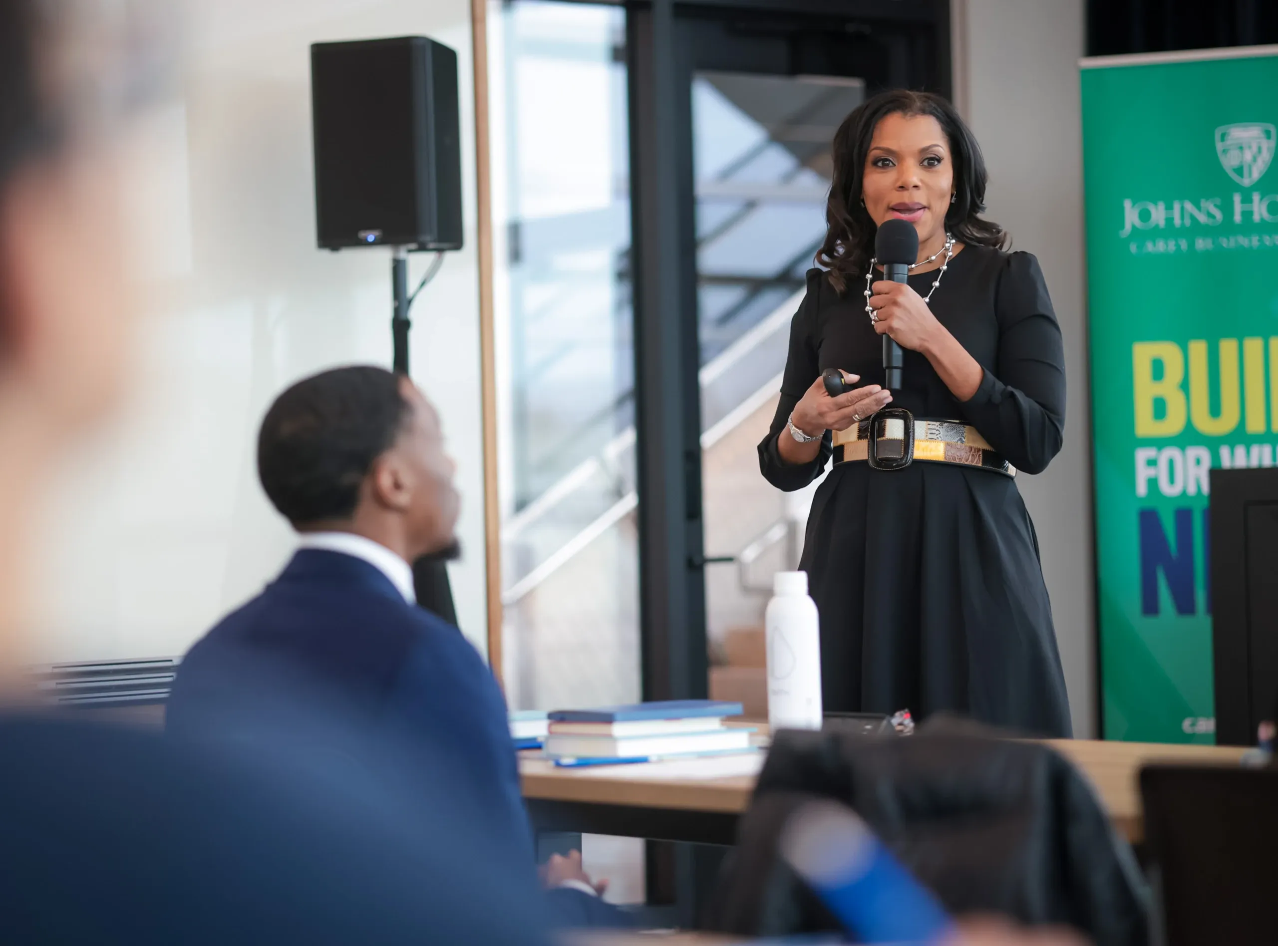 Woman speaking into microphone at a conference podium