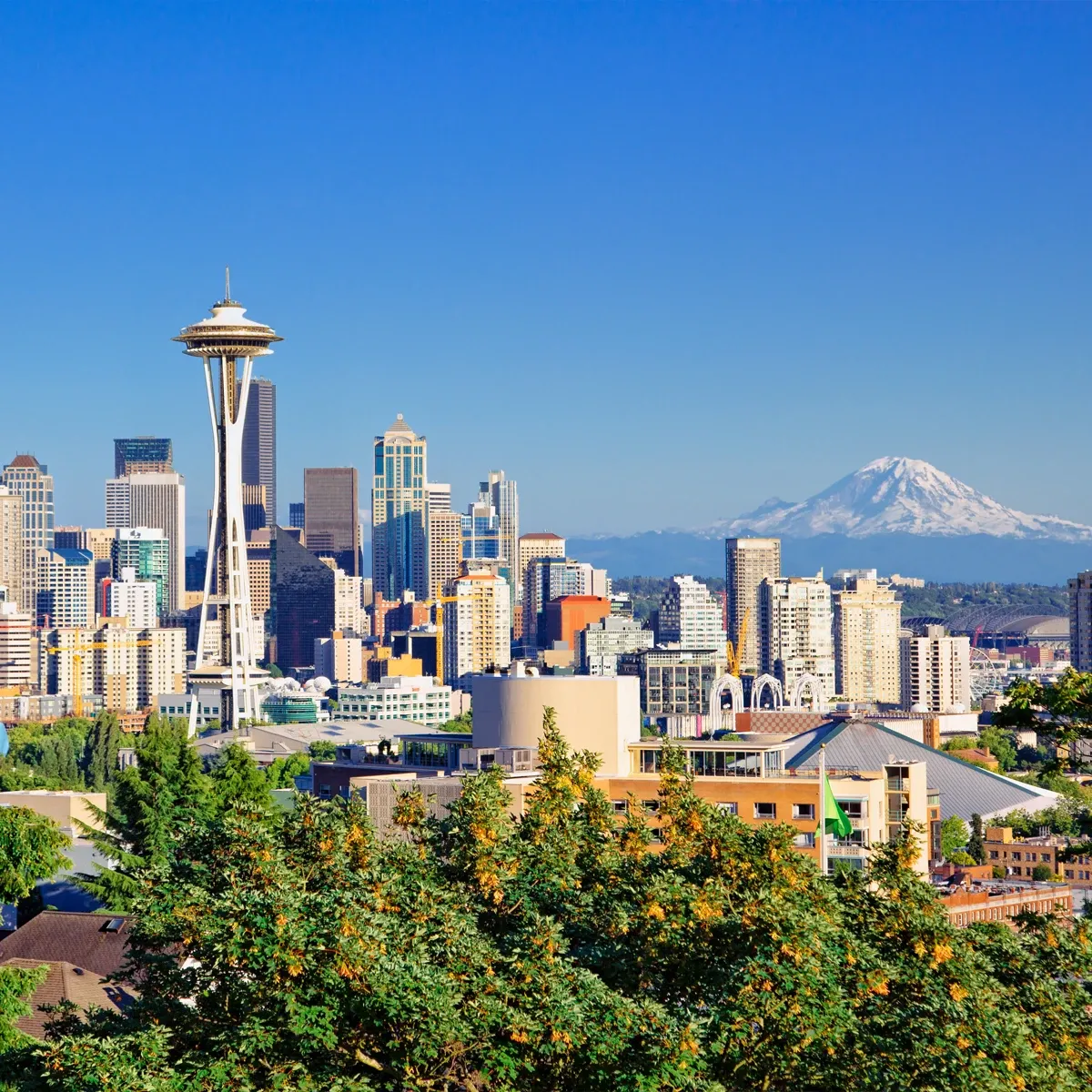 Seattle skyline with Space Needle and Mount Rainier under a clear blue sky