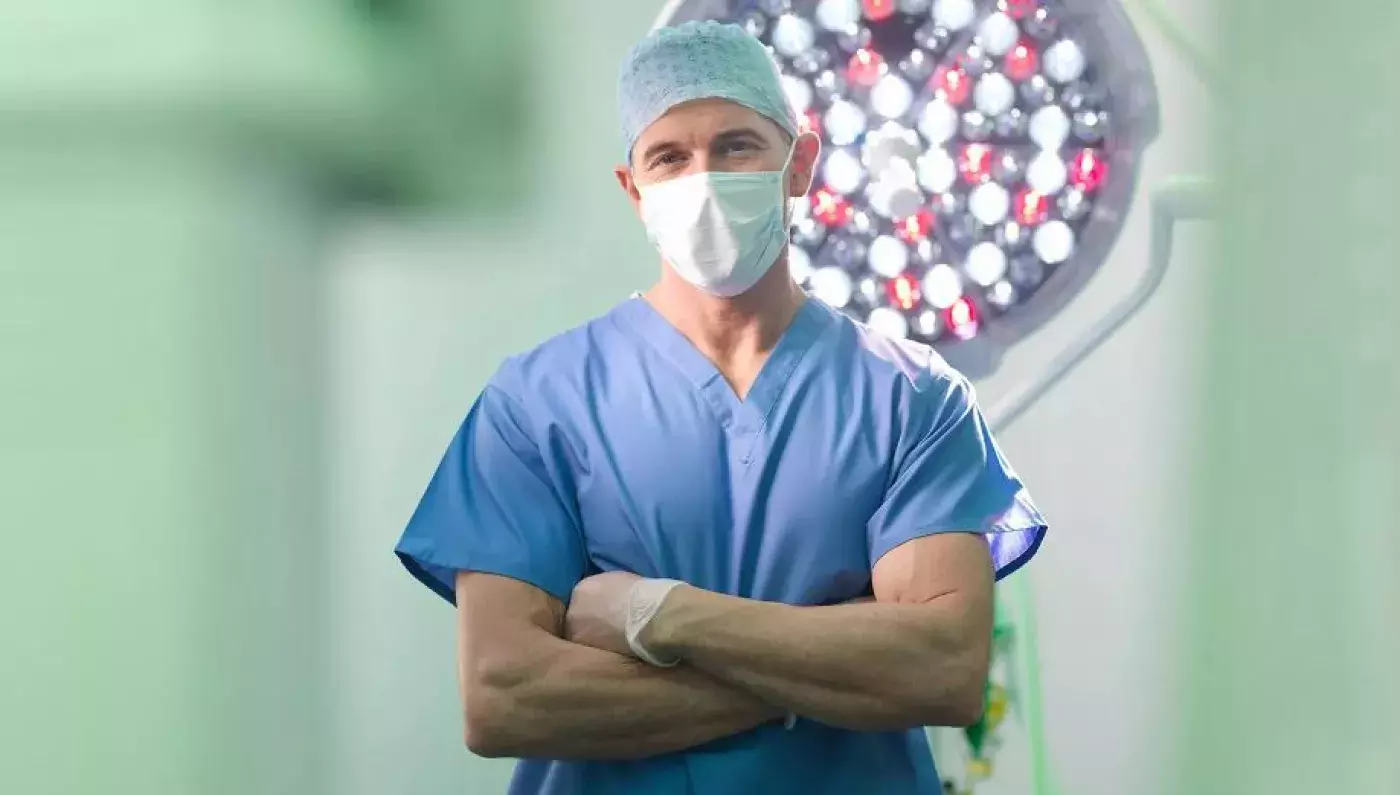 surgeon in scrubs and mask