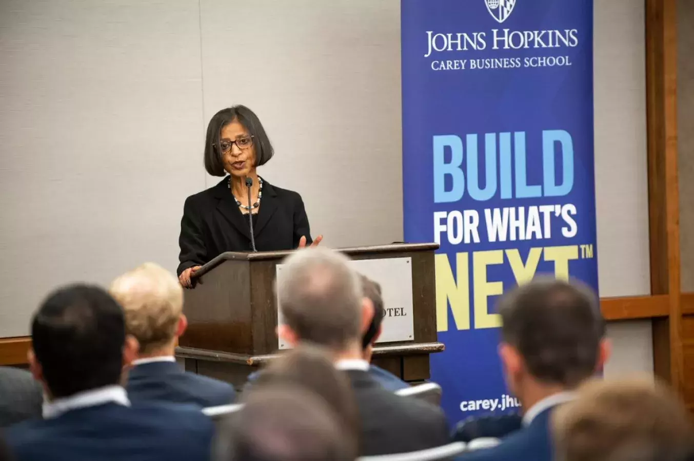 ritu agarwal speaking at a podium 