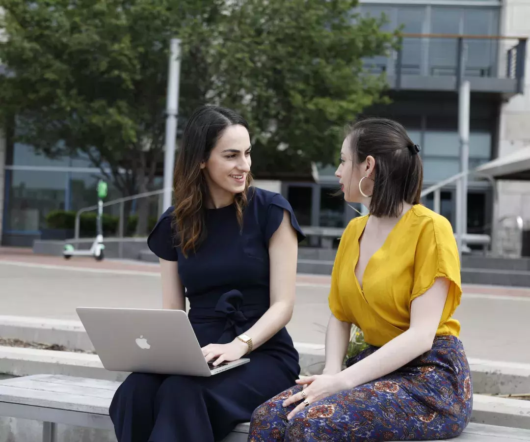 two student talking outside of the baltimore campus of johns hopkins carey business school