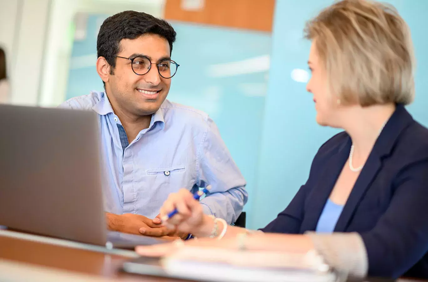 two people mentoring while sitting at a laptop