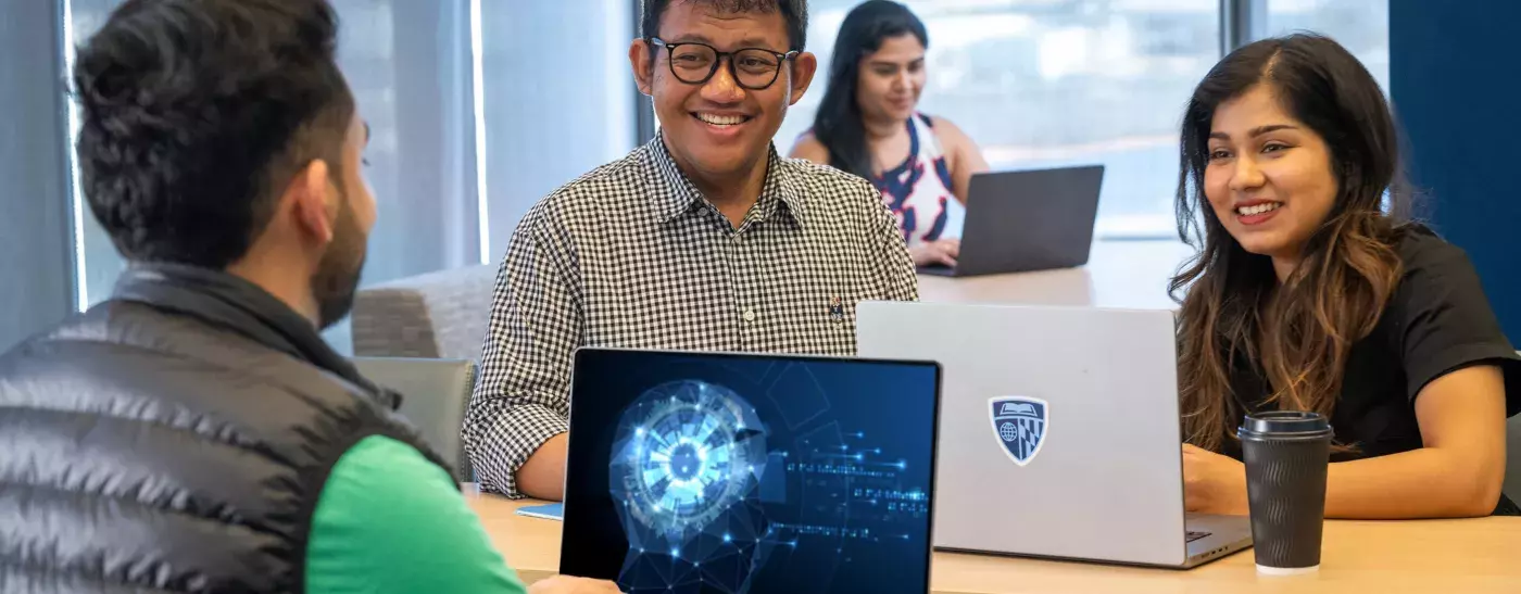 three AI students sitting at a table working and another student in the background studying alone by an window with a view.