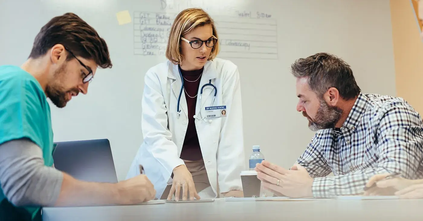 Health care professional with two interested listeners
