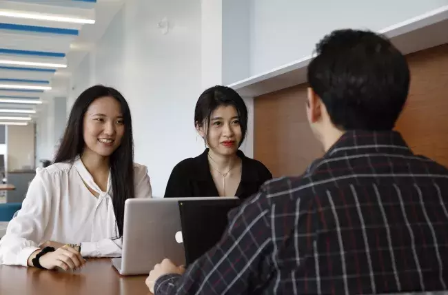 students working at a table together