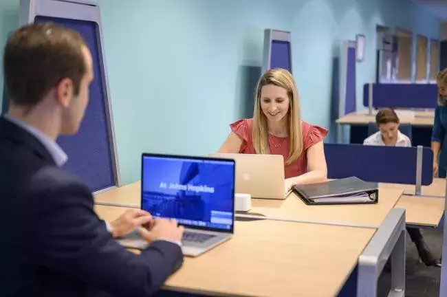 Two JHU carey MBA students working together at a desk