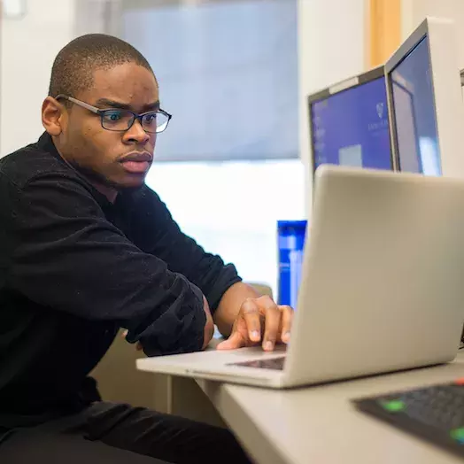 student working on his computer