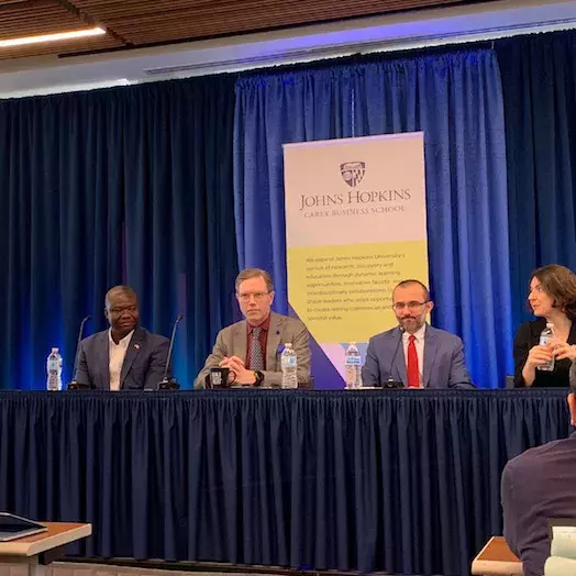 panel discussion by four Carey business school professors with a Johns Hapins Carey business school graphic in background