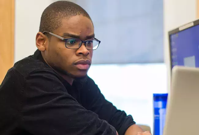 student sitting at a laptop