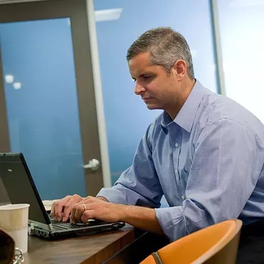 man working at his laptop computer