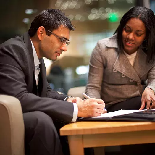 two carey business school students talking