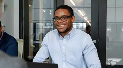 student working at his computer at johns hopkins carey business school