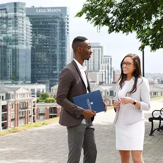 2 students outside the Baltimore campus talking