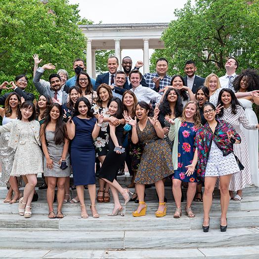 a group photo of about 30 Carey Business school graduates of May 2021 standing on steps outside