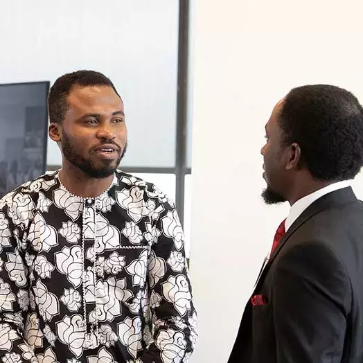 two students speaking together at a conference