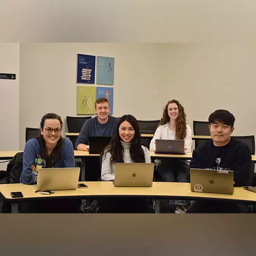 students in classroom with laptops