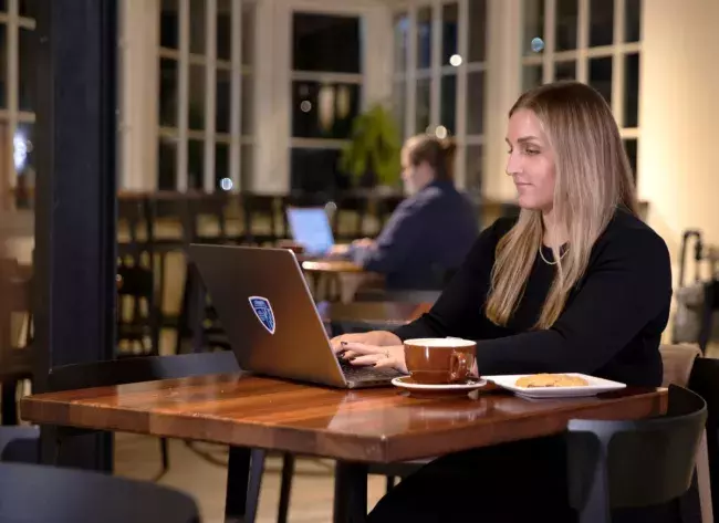 woman at table with laptop