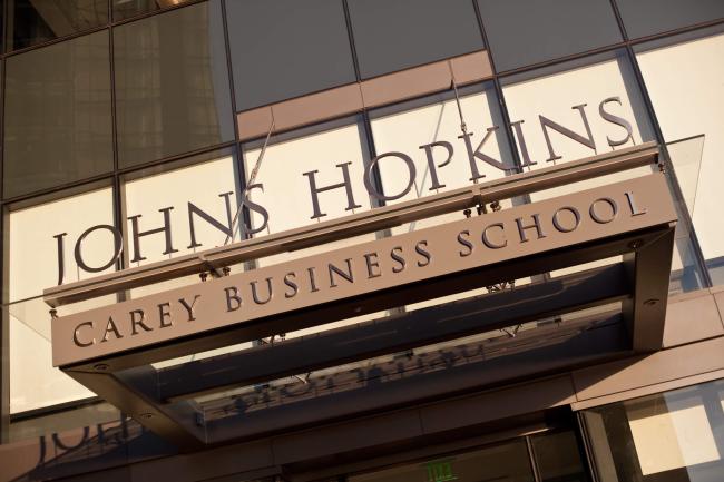 Carey business school front entrance building name in metallic letters on the facade