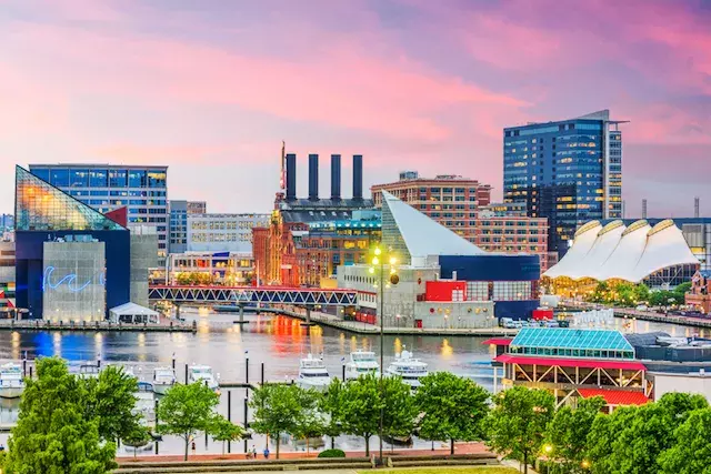 Baltimore Harbor from a distance at dusk with the lights just turning on