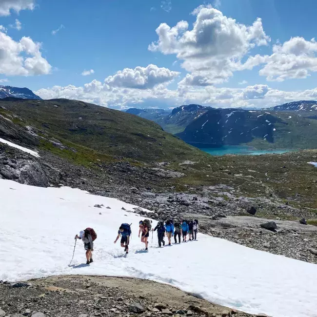 a group of hikers trekking across mountain tundra in Norway