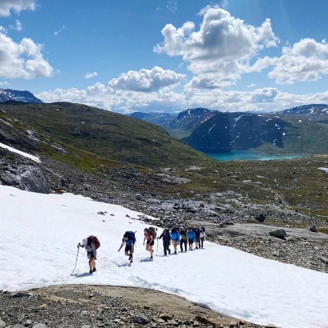 a group of hikers trekking across mountain tundra in Norway