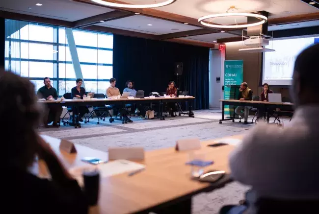 People sitting around a table for a discussion in DC about Artificial Intelligence and Health Equity