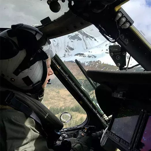 Abigail Khushf gazing at a mountain from her small plane cockpit