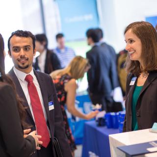 student and employer talking at the Carey Business School career fair