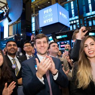 a group of students applauding at the NYSE opening bell