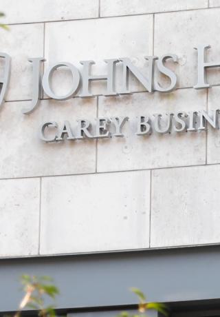 Carey Business School building front with logo