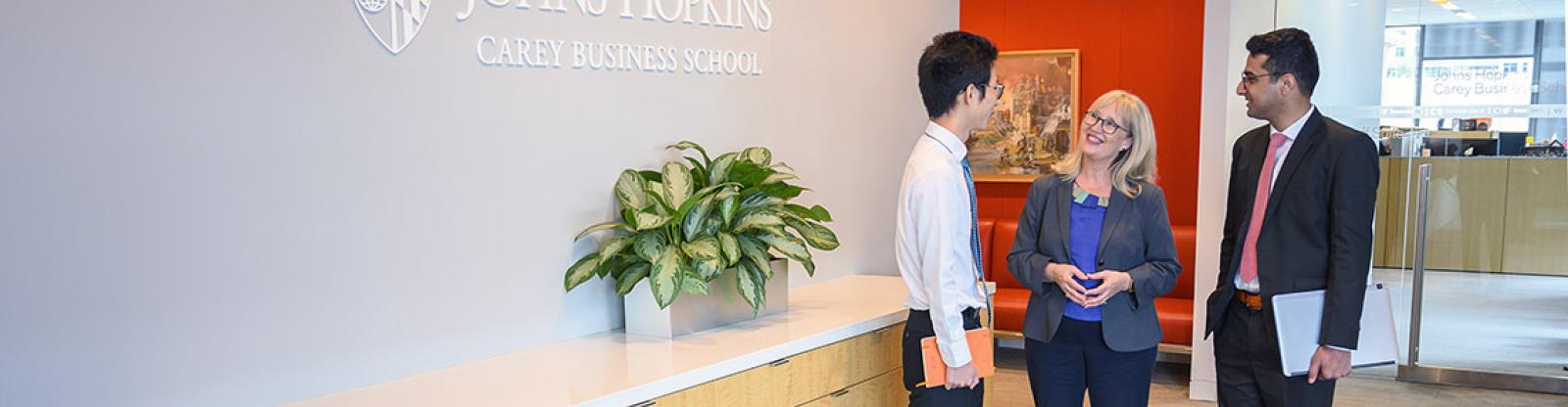 students talking with a career development coach at johns hopkins carey business school