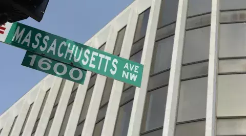 washington dc street sign next to the dc campus of the johns hopkins carey business school