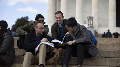students studying together in front of a monument in washington, dc