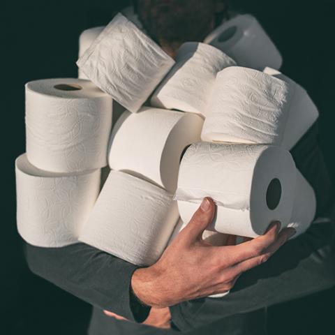 person stocking up on toilet paper after the COVID-19 pandemic
