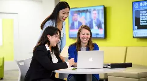 three women working on the computer together