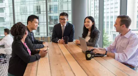 students sitting around a table discussing